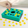 A hand is placing a yellow puzzle piece onto a green board of a shape matching puzzle game.