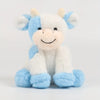 A white and light blue plush cow toy with floppy ears and a smiling face.
