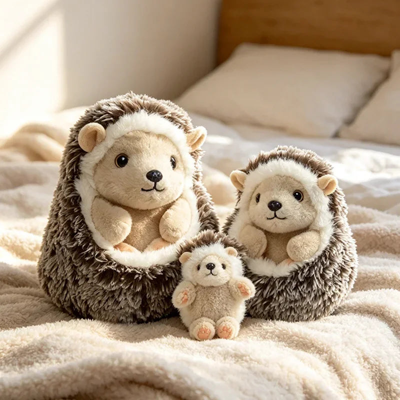 Two adorable hedgehog plush pillows with white fur resting on a beige blanket.