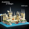 A large medieval castle set built from LEGO bricks featuring towers, walls, and minifigures on a blue base.