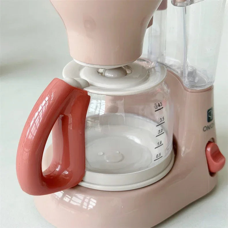 A pink kids pretend play kitchen set featuring a coffee maker, water dispenser, and toaster.