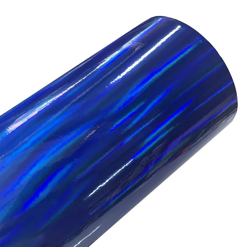 Close-up of a glossy blue vinyl wrap film with iridescent, holographic blue and purple stripes.