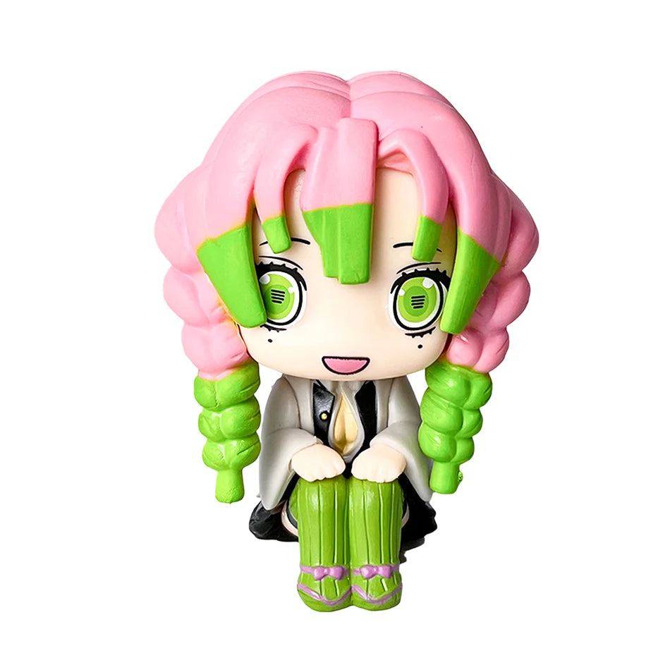 A set of four Demon Slayer anime action figures featuring characters like Tanjirou and Nezuko with pink hair and green accent