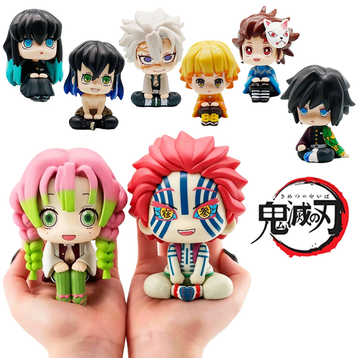 A set of Demon Slayer characters including Tanjiro and Nezuko figures displayed on a hand.