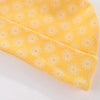 A yellow knitted baby hat with a repeating white daisy pattern.