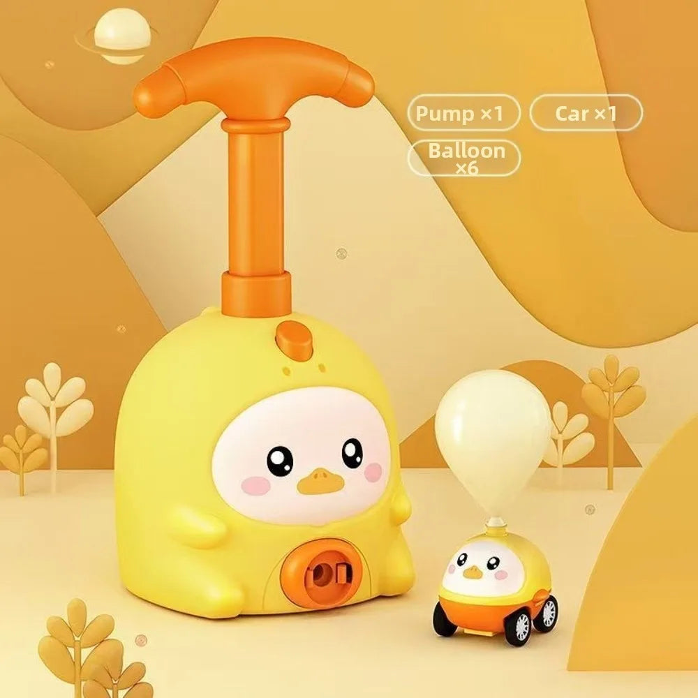 A yellow balloon-powered racing car toy with a launcher and six balloons is shown on a light background.