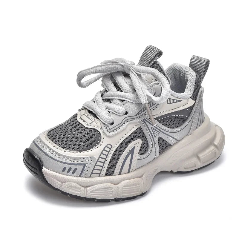 A pair of light gray breathable mesh kids running sneakers with a cushioned sole.