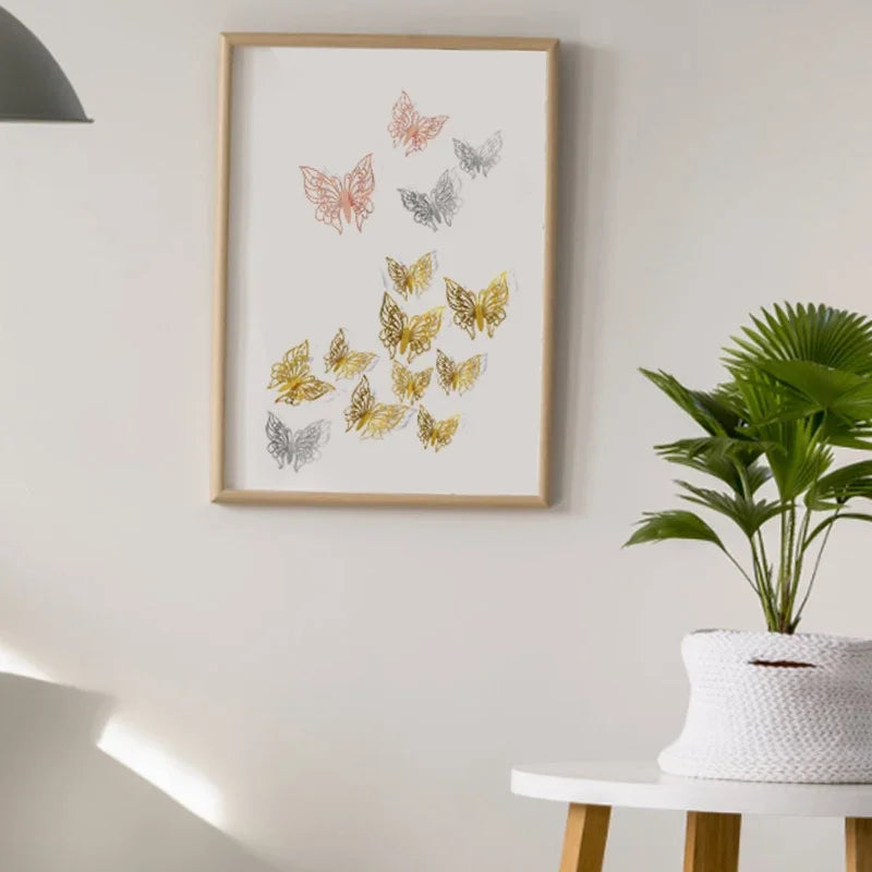 A framed watercolor illustration of various butterflies in shades of pink, gold, and gray on a white wall.