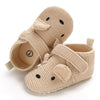 A pair of beige soft cotton baby walking shoes with a duck face design.