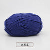 A ball of dark blue pre-dyed milk cotton yarn for knitting and crochet.