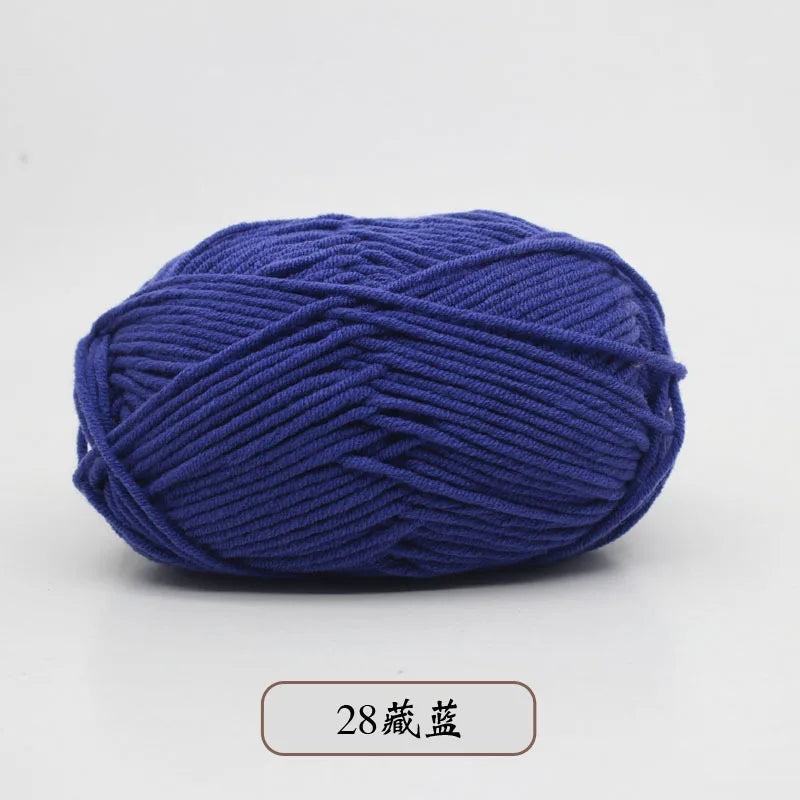 A ball of dark blue pre-dyed milk cotton yarn for knitting and crochet.