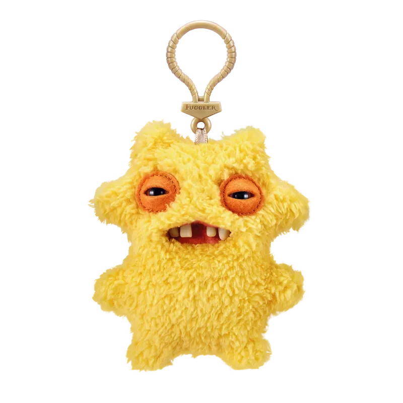 A yellow, fluffy plush monster with large orange eyes and a toothy grin attached to a keychain.