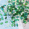 A pile of green and blue water drop Czech glass beads for jewelry making