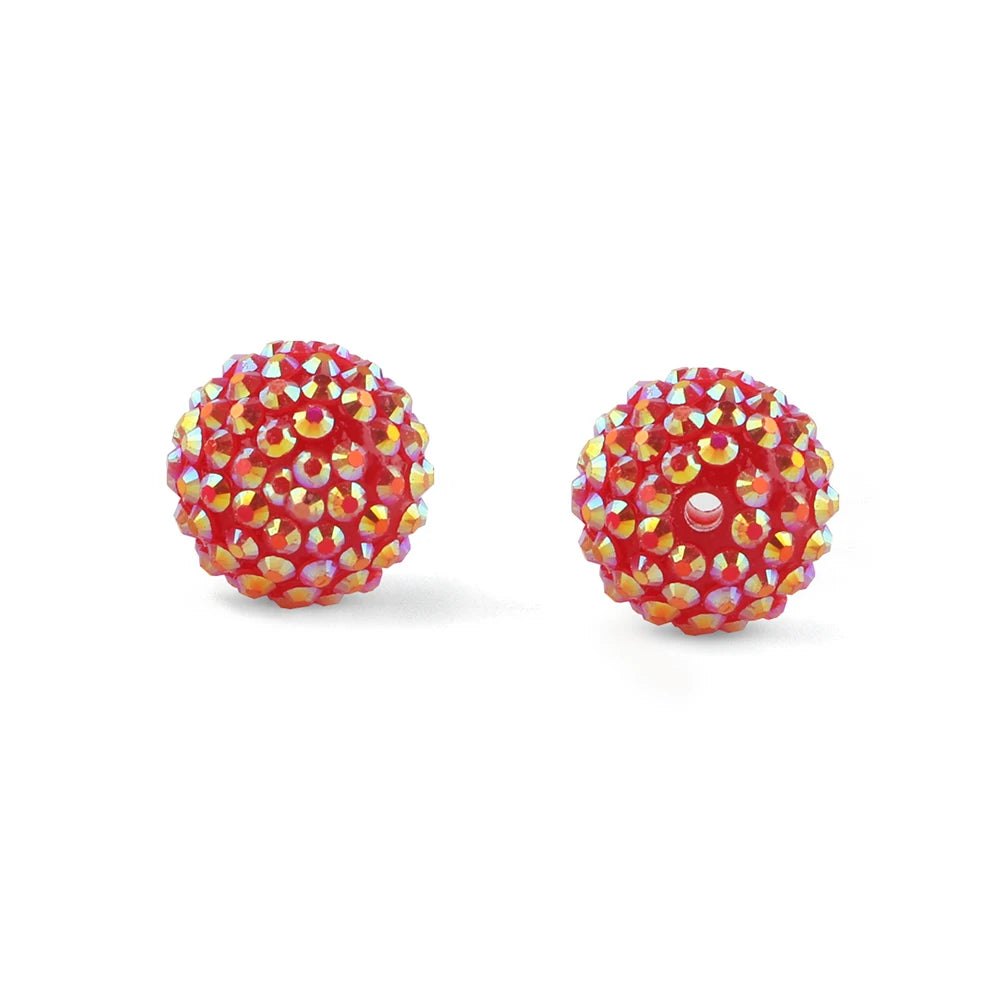 A close-up view of a red and gold rhinestone resin bayberry ball bead.