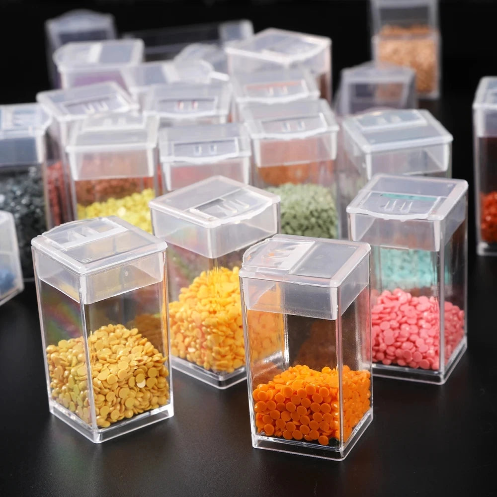 Clear plastic storage bottles filled with various colored beads for diamond painting and crafts