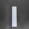 A white flexible silicone mold for resin bookmarks is shown against a dark gray surface.
