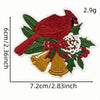 A red bird patch featuring a bow and yellow bells on green foliage.
