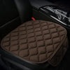 A brown quilted anti-slip car seat cushion set is shown placed in the interior of a dark vehicle.