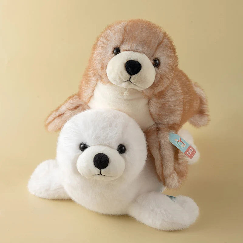 A soft, realistic seal plush toy with light brown fur and a white belly is shown against a neutral background.