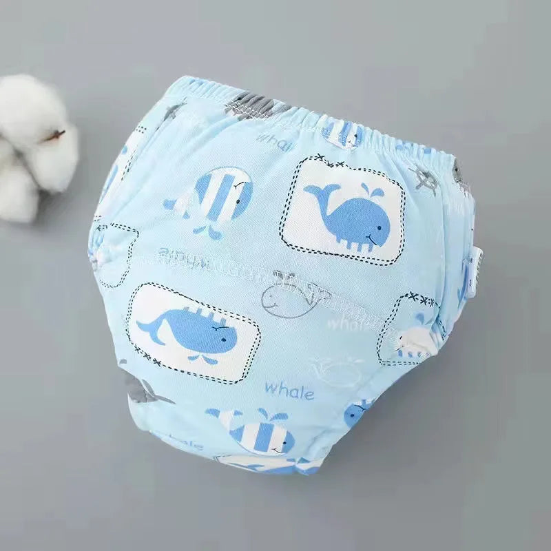 Pantalones de entrenamiento lavables azul claro para bebés con diseños de ballena y animales a rayas