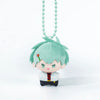A small plush charm of an anime-style character with teal hair and a red accessory.