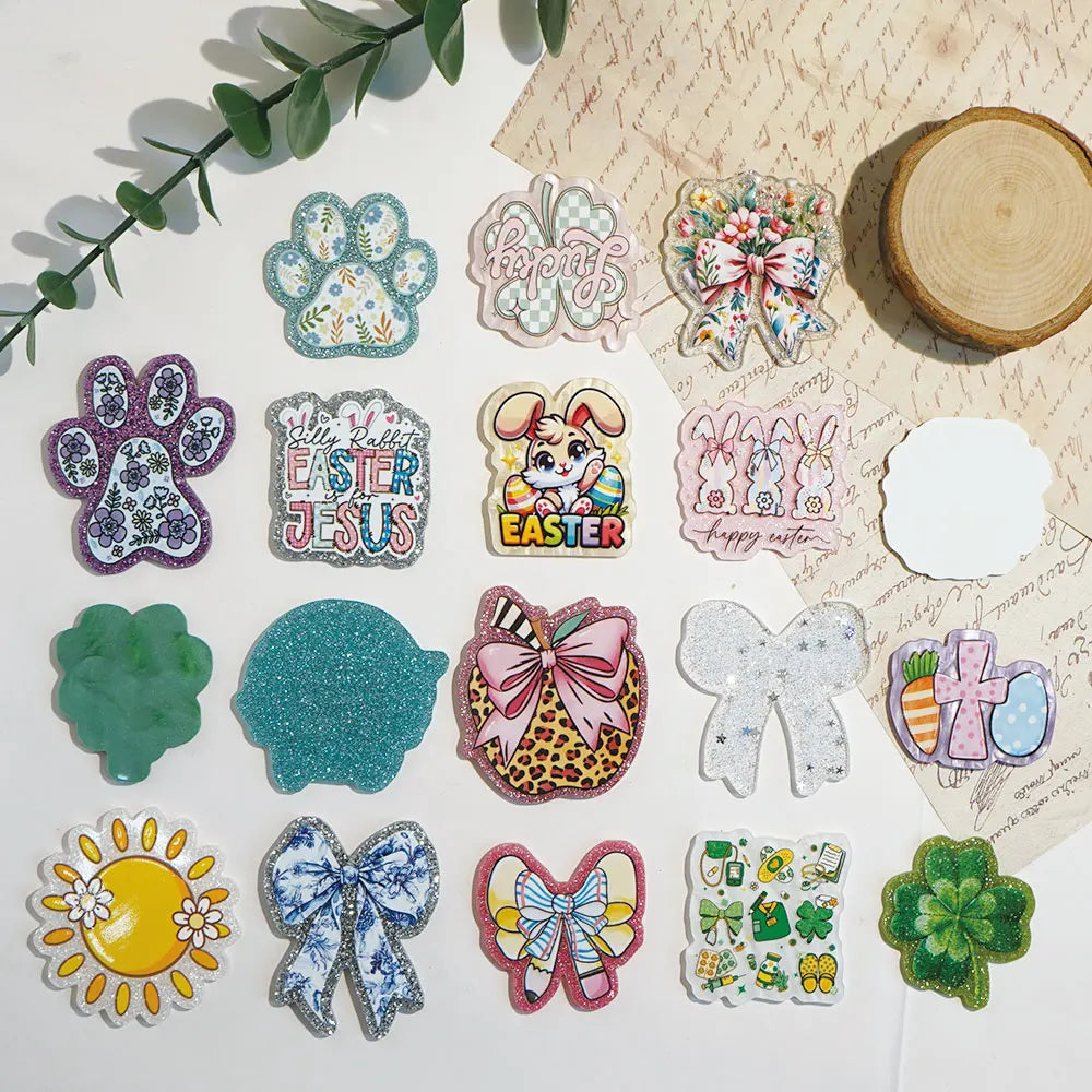 A collection of 10 glitter acrylic flatback resin cabochons featuring paw prints, Easter themes, and various floral shapes.