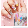 A hand displays various pastel-colored polymer clay sprinkles and glitter for slime and craft decoration.
