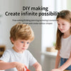 A young boy is using a craft knife to cut cardboard for a DIY making kit.
