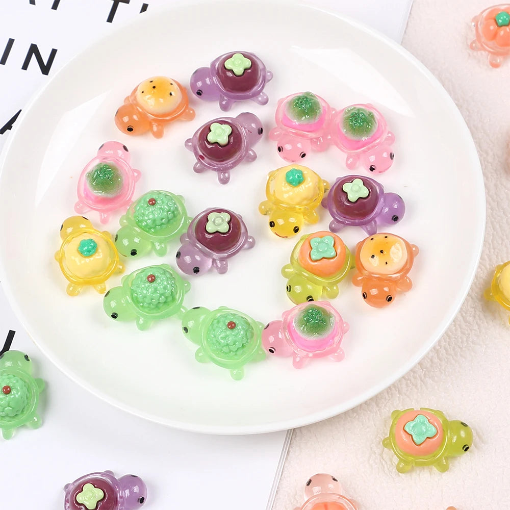 A collection of colorful, glow-in-the-dark turtle resin figurines arranged on a white plate.