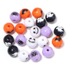 A collection of round acrylic beads in black, orange, and purple with various Halloween-themed designs like skulls and spider
