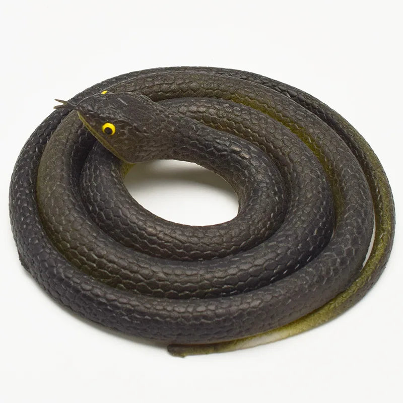 A dark rubber snake toy with a yellow eye is coiled on a white background.