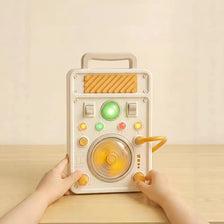 A hand is operating an interactive circuit busy board with lights and switches on a wooden table.