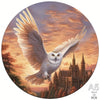 A majestic white owl with spread wings soaring against a sunset sky above a cityscape.