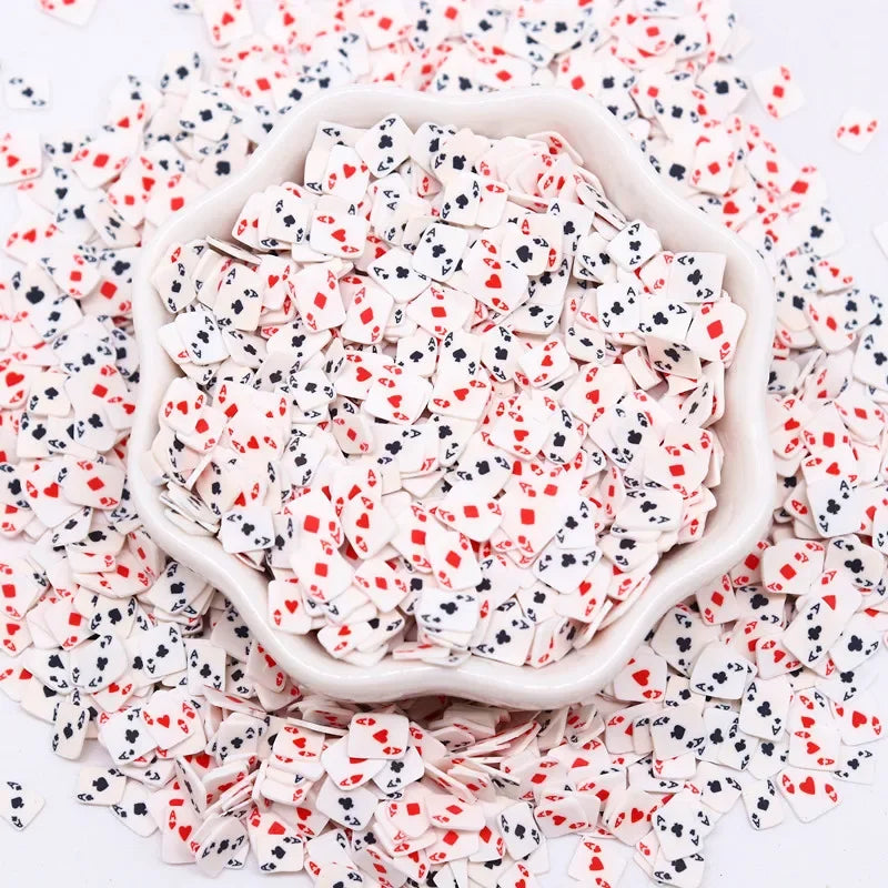 A pile of pink and white polymer clay sprinkles mix scattered on a white surface.