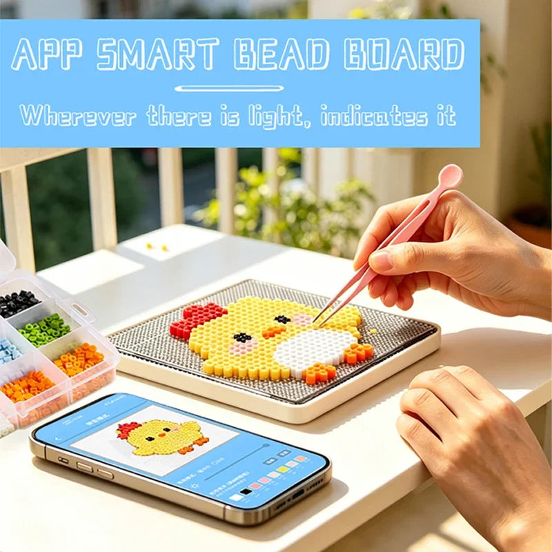 A hand is placing a pink tool on a bead board with yellow pixel art beads, next to a smartphone displaying an app interface.