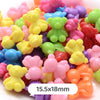 A close-up of colorful pastel bear-shaped acrylic craft beads in various shades of pink, yellow, green, and purple.