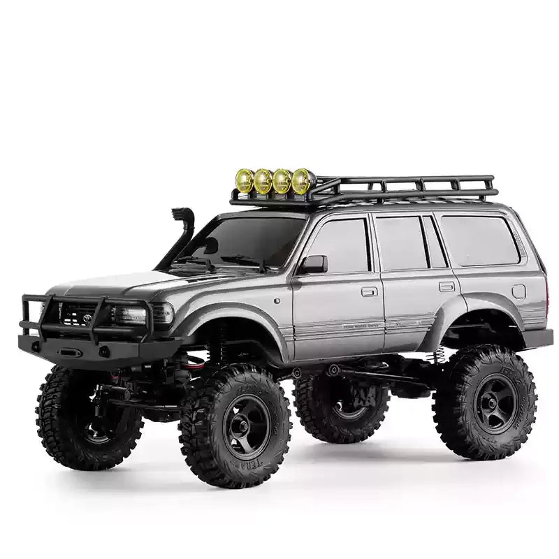A silver 1:18 scale remote control off-road climbing car with a black roof rack and yellow lights.