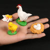 A set of three ceramic figurines depicting a hen and chicks, used for animal life cycle learning.