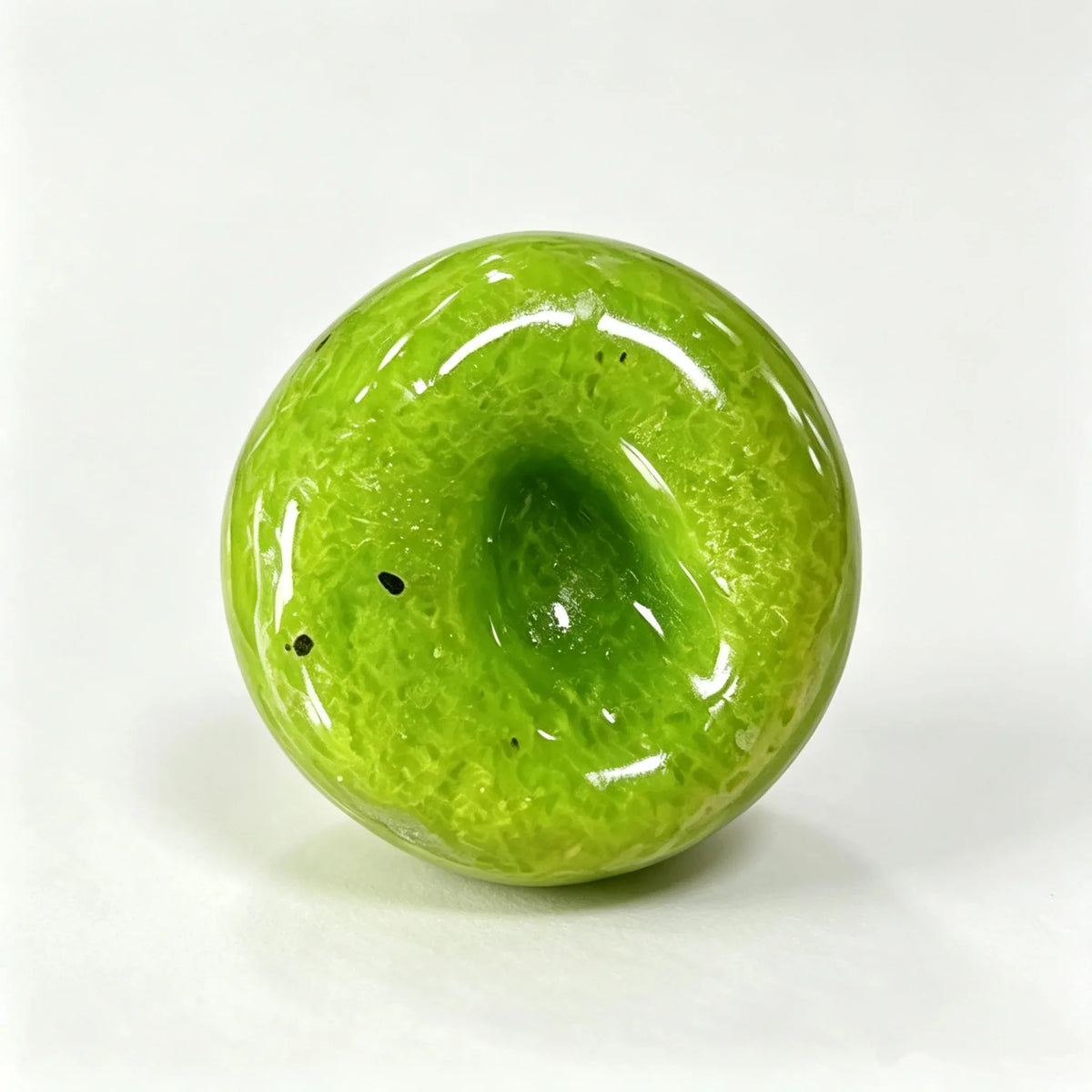 A glossy, lime green kiwi and watermelon smoothie slime squishy stress relief toy.
