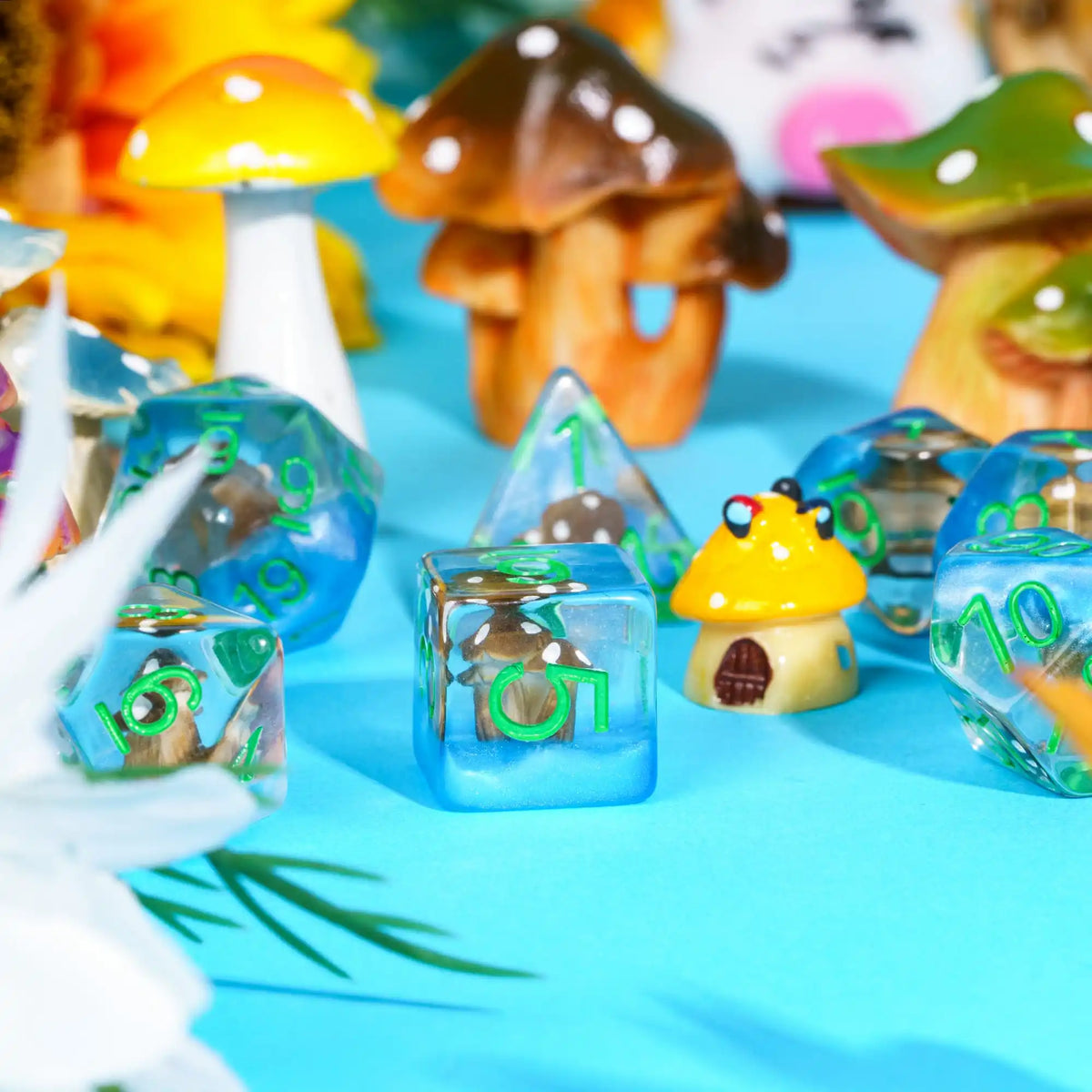 A collection of colorful polyhedral dice shaped like mushrooms and other fantasy items on a blue background.