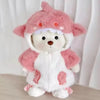 A pink and white plush teddy bear with a hood and a dress.