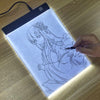 A hand draws a detailed line art of a girl on an illuminated LED drawing copy pad.