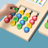 A hand places colored wooden shapes onto a matching board for a kids game.