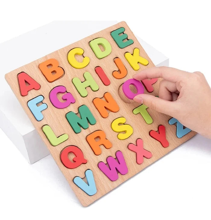 A wooden alphabet puzzle set with colorful letters A through Z is being held by a hand.