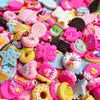Assorted pink and yellow resin flatbacks for DIY crafts and jewelry making