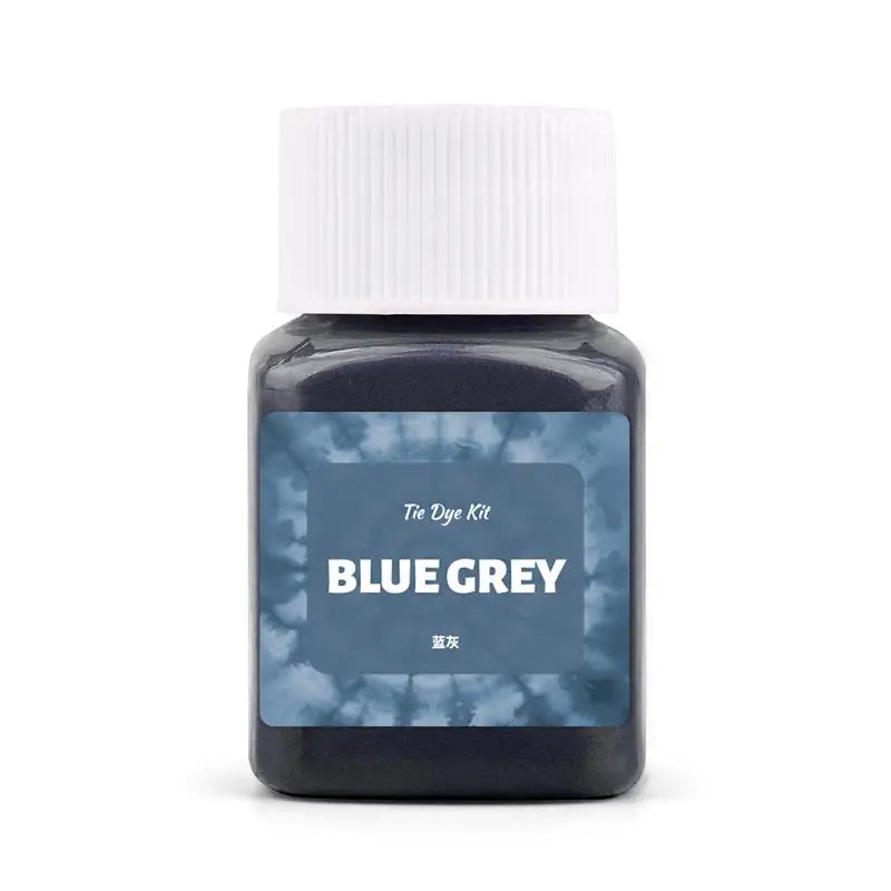 A dark blue-grey textile fabric dye kit in a white cap and glass jar.