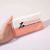 A hand holds a package of OUMMAA air dry clay in a light pink wrapper.