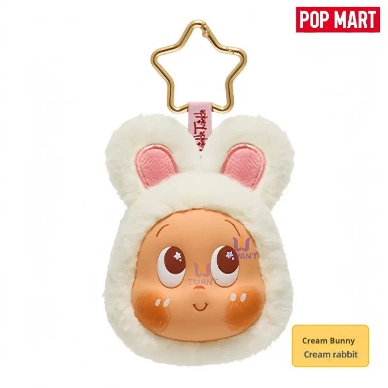 A fluffy cream bunny earbud case cover with pink inner ears and a gold hook.