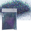 A small plastic bag filled with iridescent purple glitter powder next to a pile of loose holographic glitter.