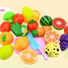 A set of 15 pretend play cutting food toys including various fruits and vegetables like apples, tomatoes, and citrus slices.